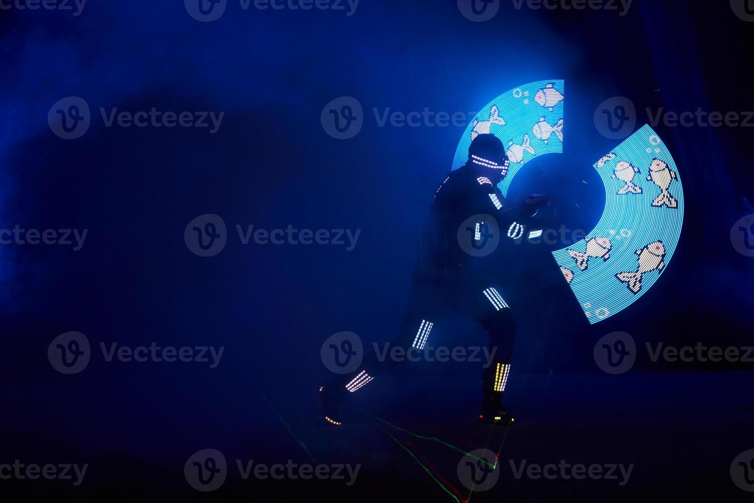 Laser show performance, dancers in led suits with LED lamp, very beautiful night club performance, party photo