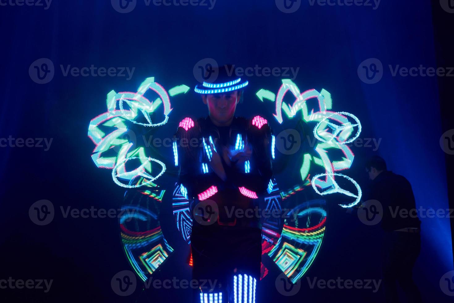 Laser show performance, dancers in led suits with LED lamp, very beautiful night club performance, party photo