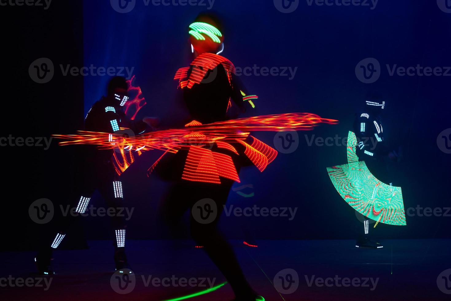 Laser show performance, dancers in led suits with LED lamp, very beautiful night club performance, party photo