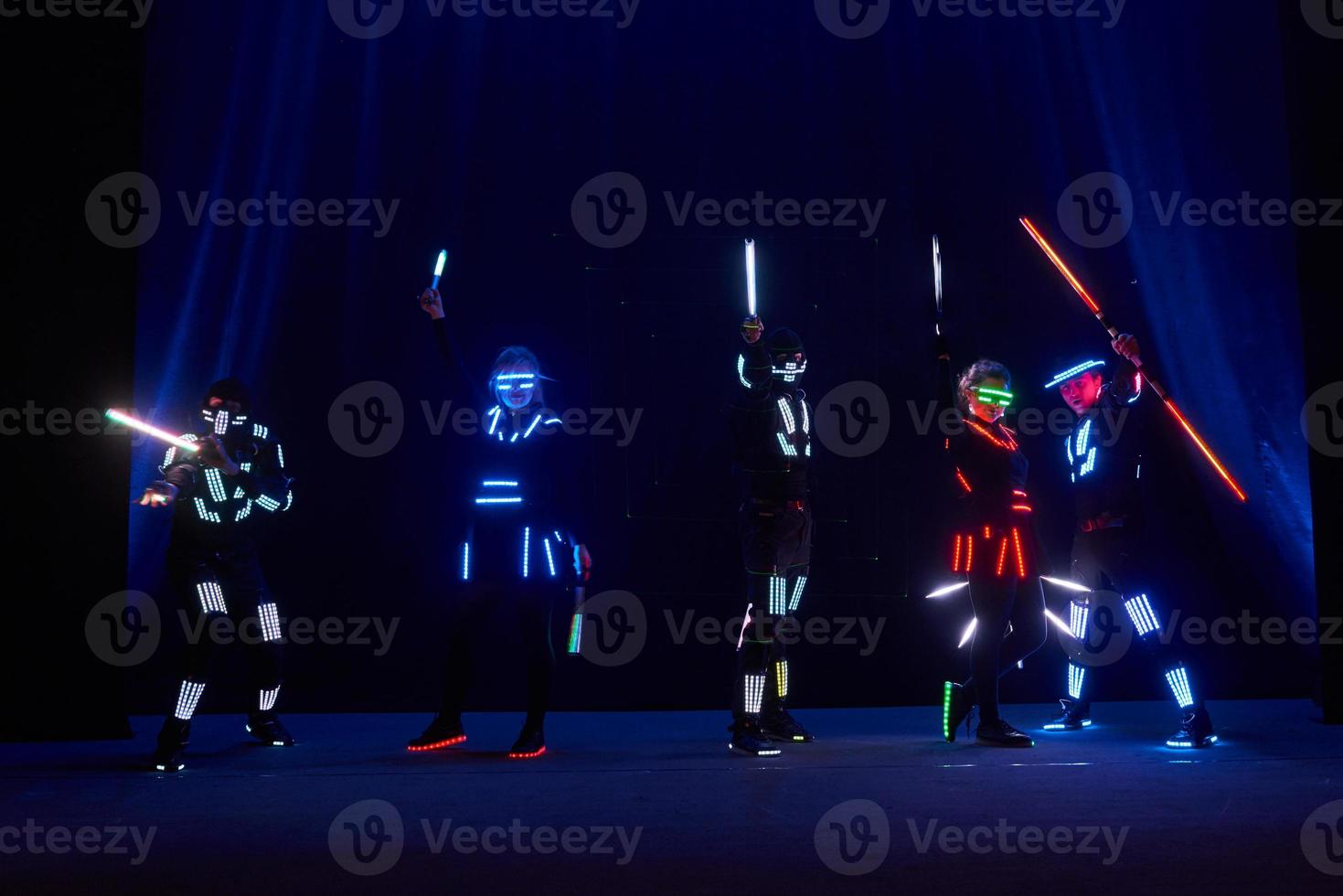 Laser show performance, dancers in led suits with LED lamp, very beautiful night club performance, party photo