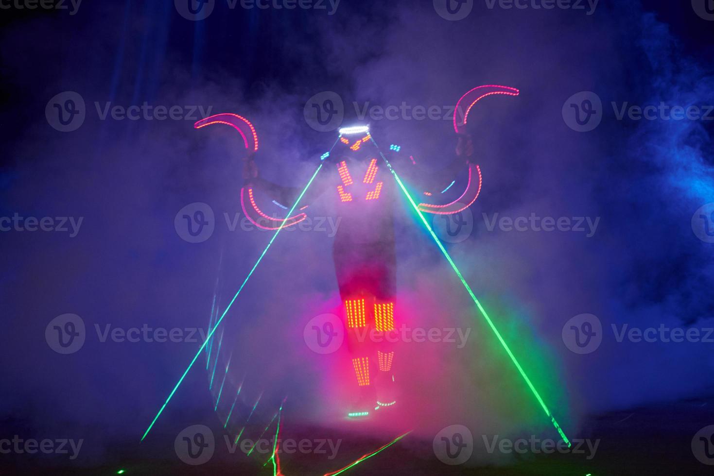 Laser show performance, dancers in led suits with LED lamp, very beautiful night club performance, party photo