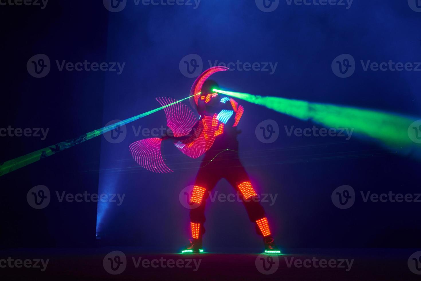 Laser show performance, dancers in led suits with LED lamp, very beautiful night club performance, party photo