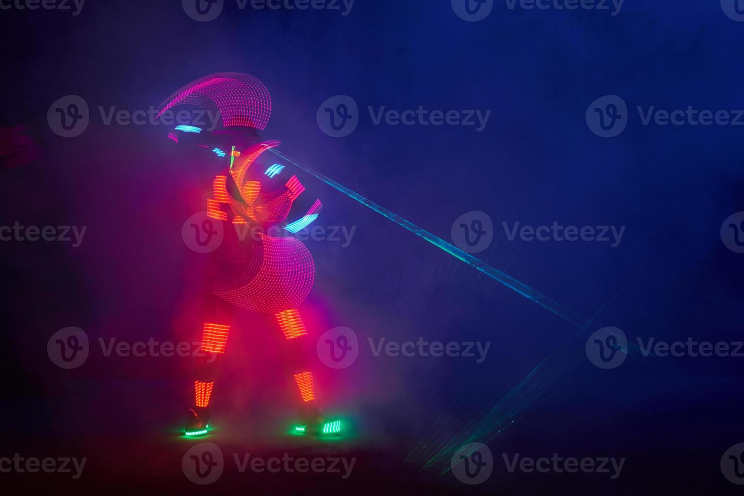 Laser show performance, dancers in led suits with LED lamp, very beautiful night club performance, party photo