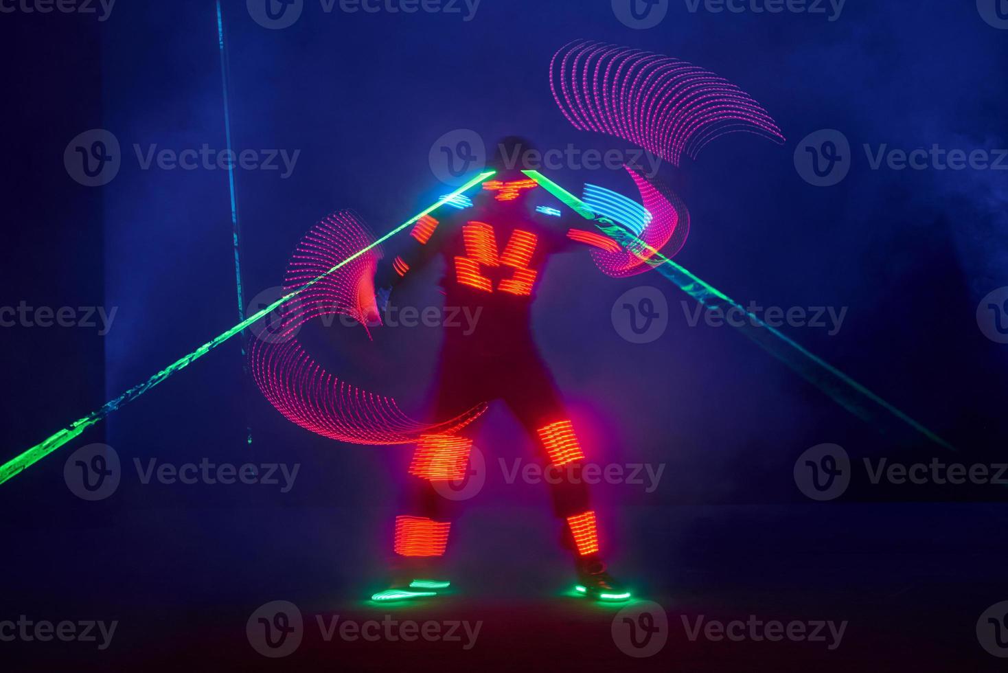 Laser show performance, dancers in led suits with LED lamp, very beautiful night club performance, party photo