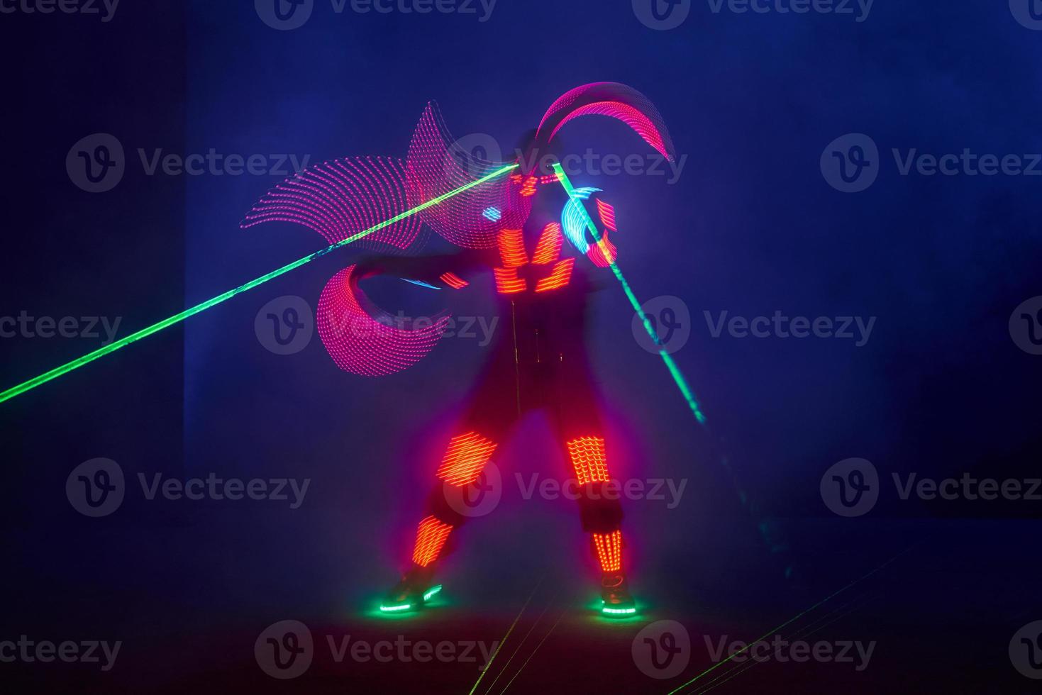 Laser show performance, dancers in led suits with LED lamp, very beautiful night club performance, party photo