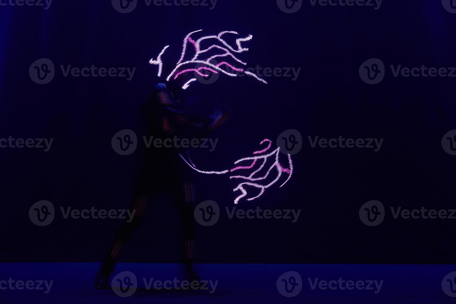 Laser show performance, dancers in led suits with LED lamp, very beautiful night club performance, party photo