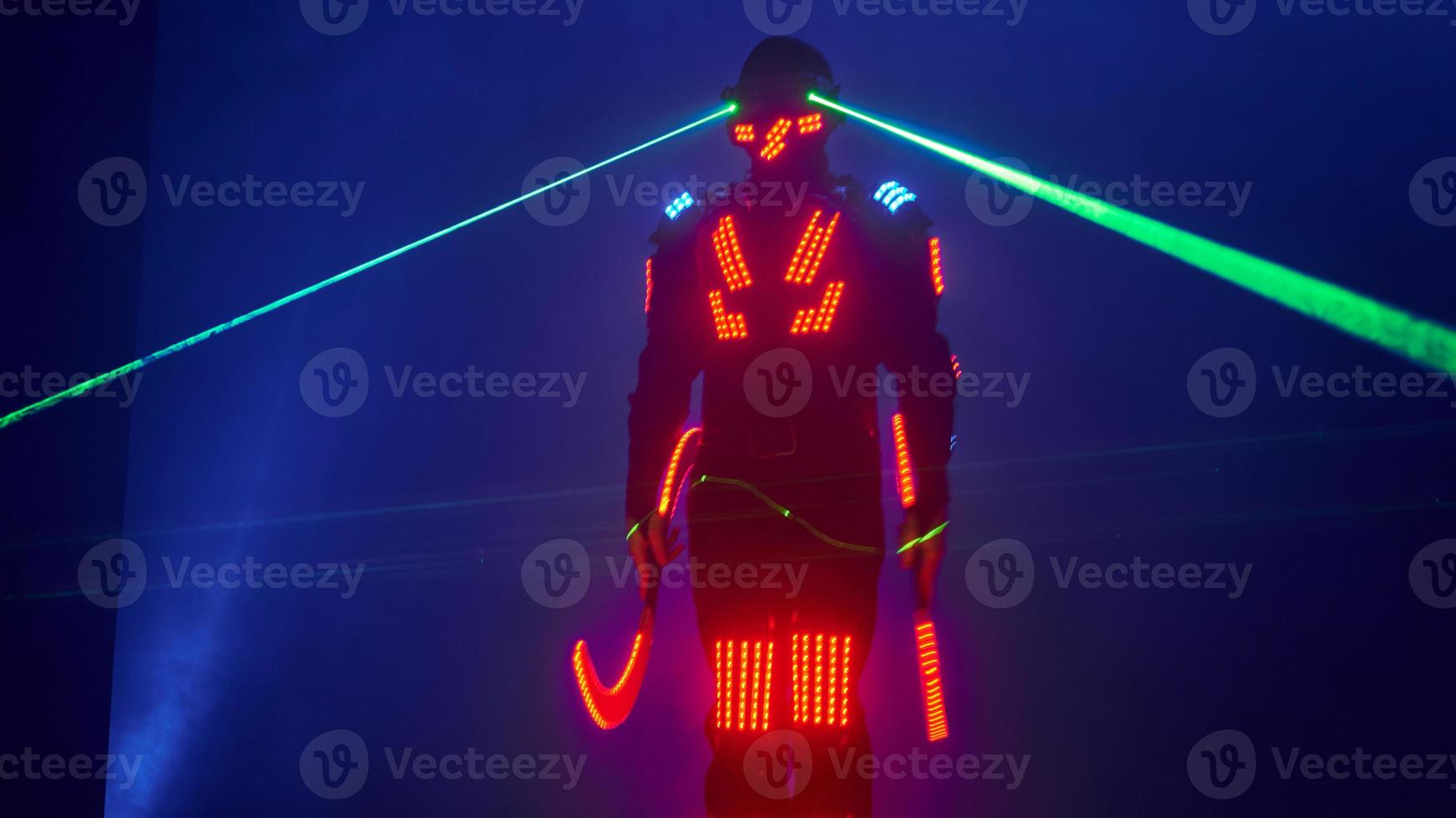 Laser show performance, dancers in led suits with LED lamp, very beautiful night club performance, party photo