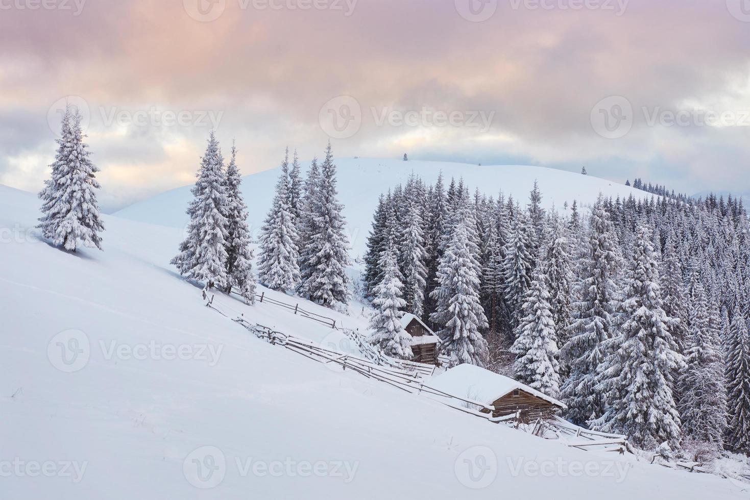 Majestic sunset at small village on a snowy hill under Ukrainian. Villages in the mountains in winter. Beautiful winter landscape. Carpathians, Ukraine, Europe photo