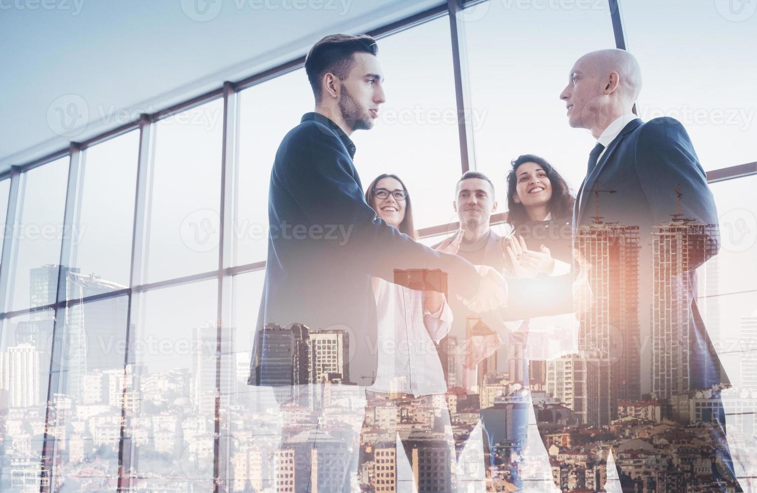 Two confident business man shaking hands during a meeting in the office, success, dealing, greeting and partner concept photo