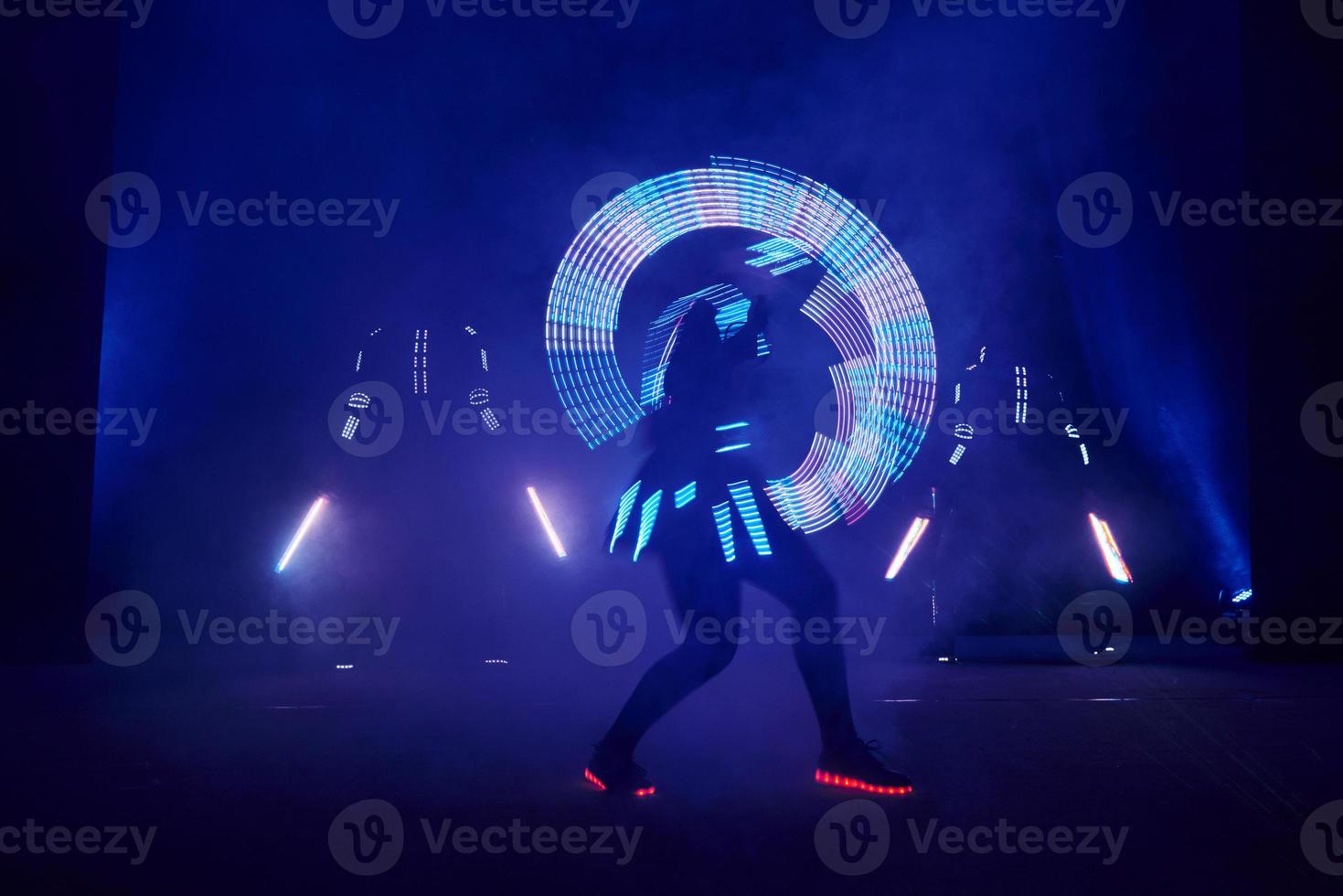 Laser show performance, dancers in led suits with LED lamp, very beautiful night club performance, party photo