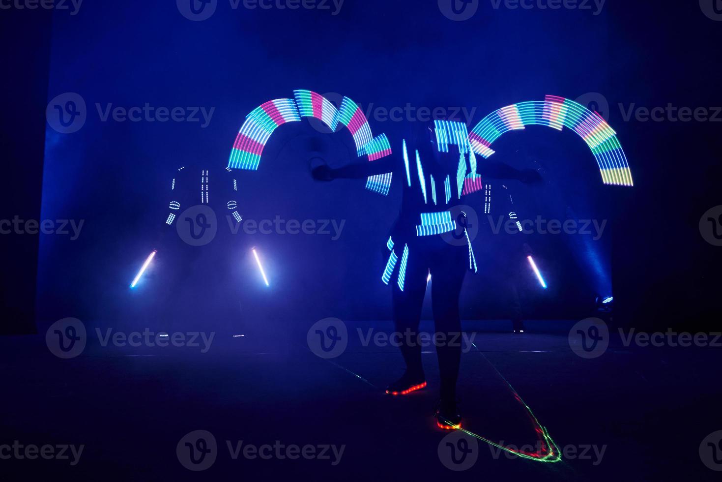 Laser show performance, dancers in led suits with LED lamp, very beautiful night club performance, party photo