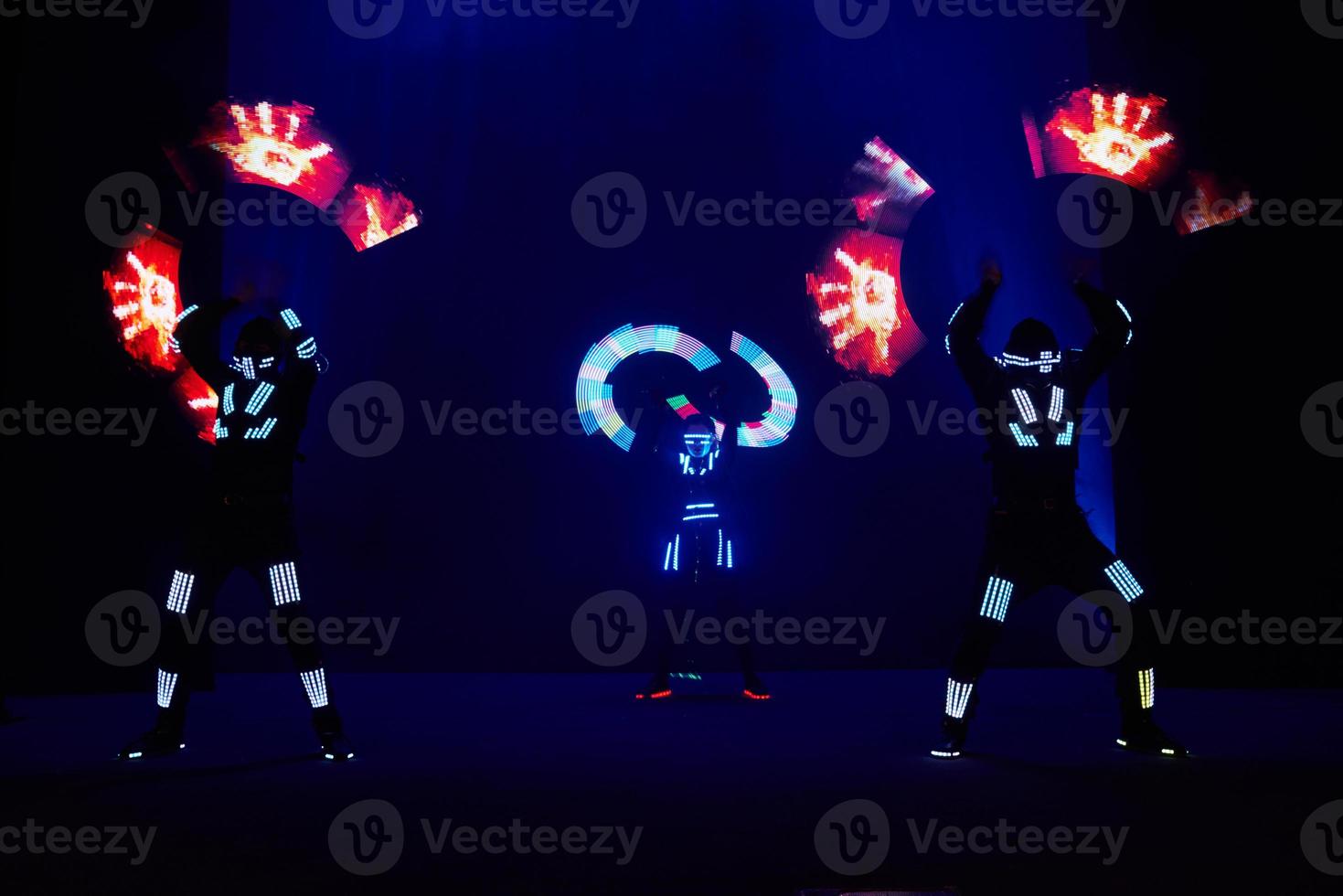 Laser show performance, dancers in led suits with LED lamp, very beautiful night club performance, party photo