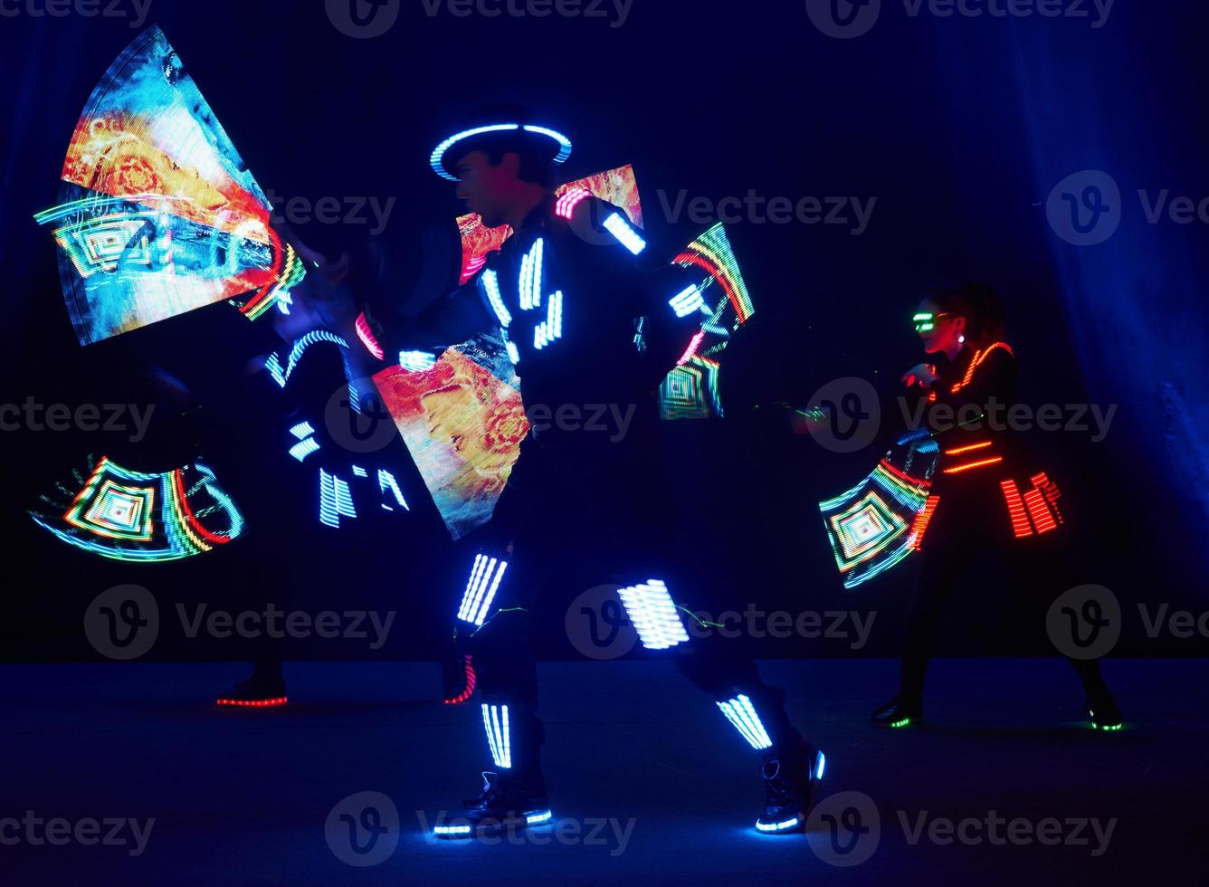Laser show performance, dancers in led suits with LED lamp, very beautiful night club performance, party photo