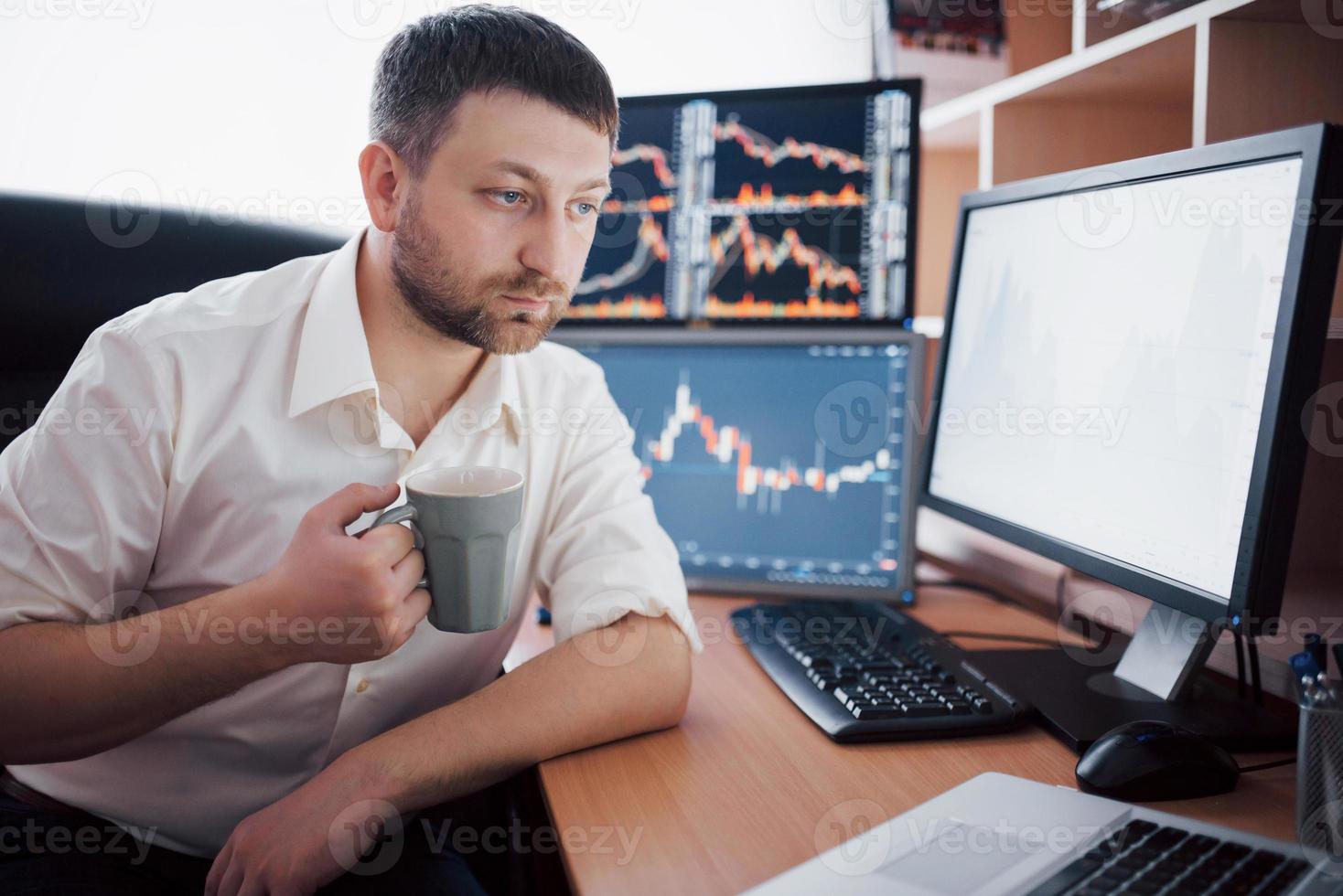 Stockbroker in shirt is working in a monitoring room with display screens. Stock Exchange Trading Forex Finance Graphic Concept. Businessmen trading stocks online photo