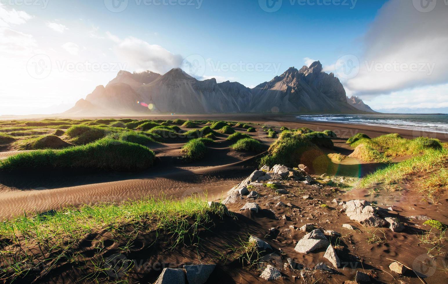 Fantastic west of the mountains and volcanic lava sand dunes on the beach Stokksness, Iceland. Colorful summer morning Iceland, Europe photo