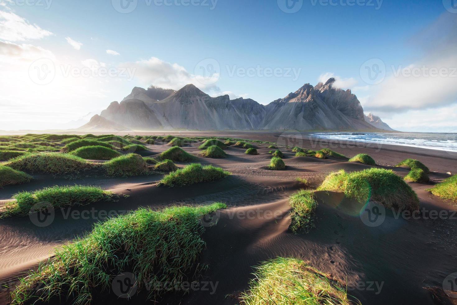 Fantastic west of the mountains and volcanic lava sand dunes on the beach Stokksness, Iceland. Colorful summer morning Iceland, Europe photo