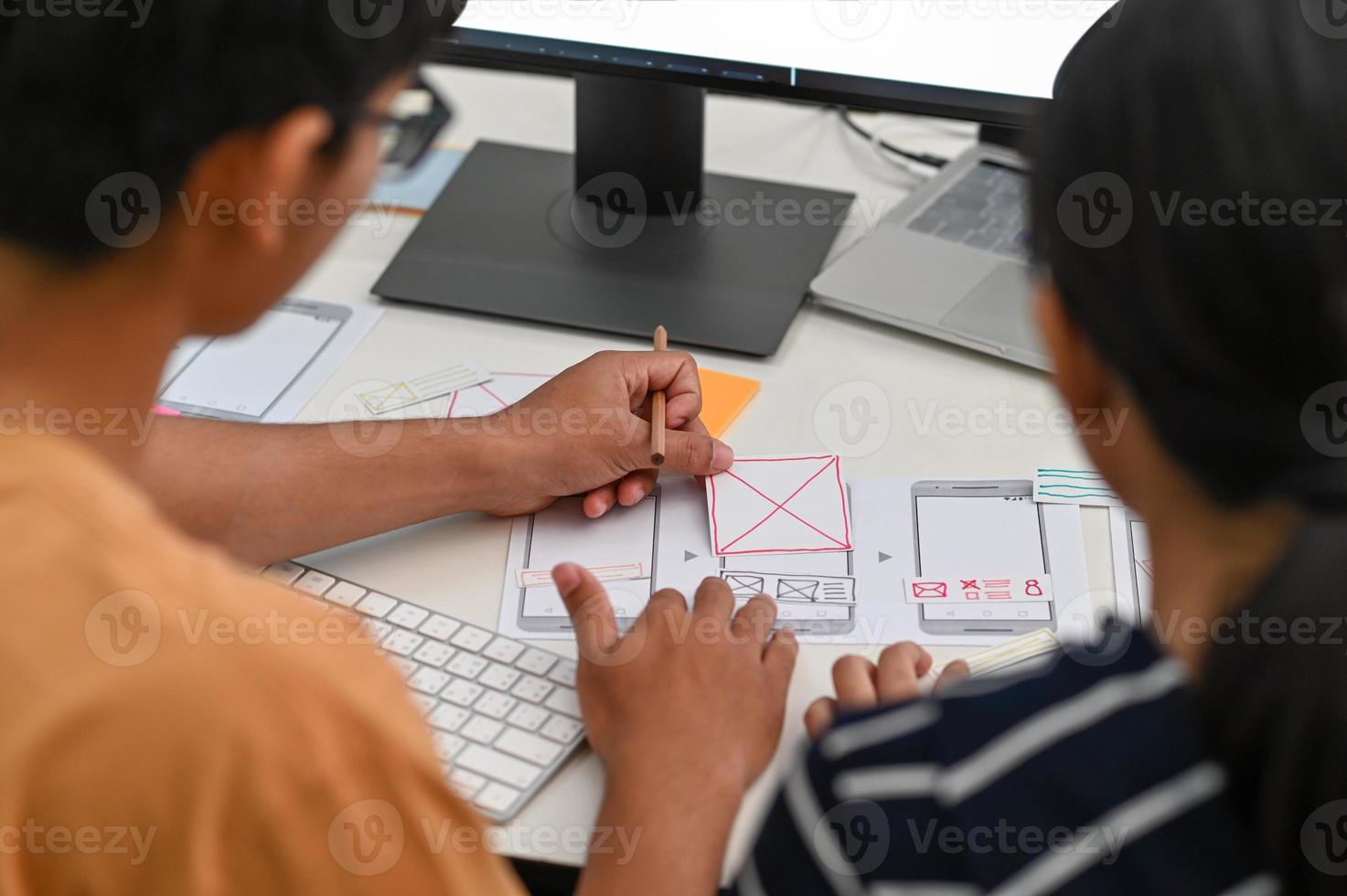 UX , UI graphic designer team drawing application for smartphone. photo