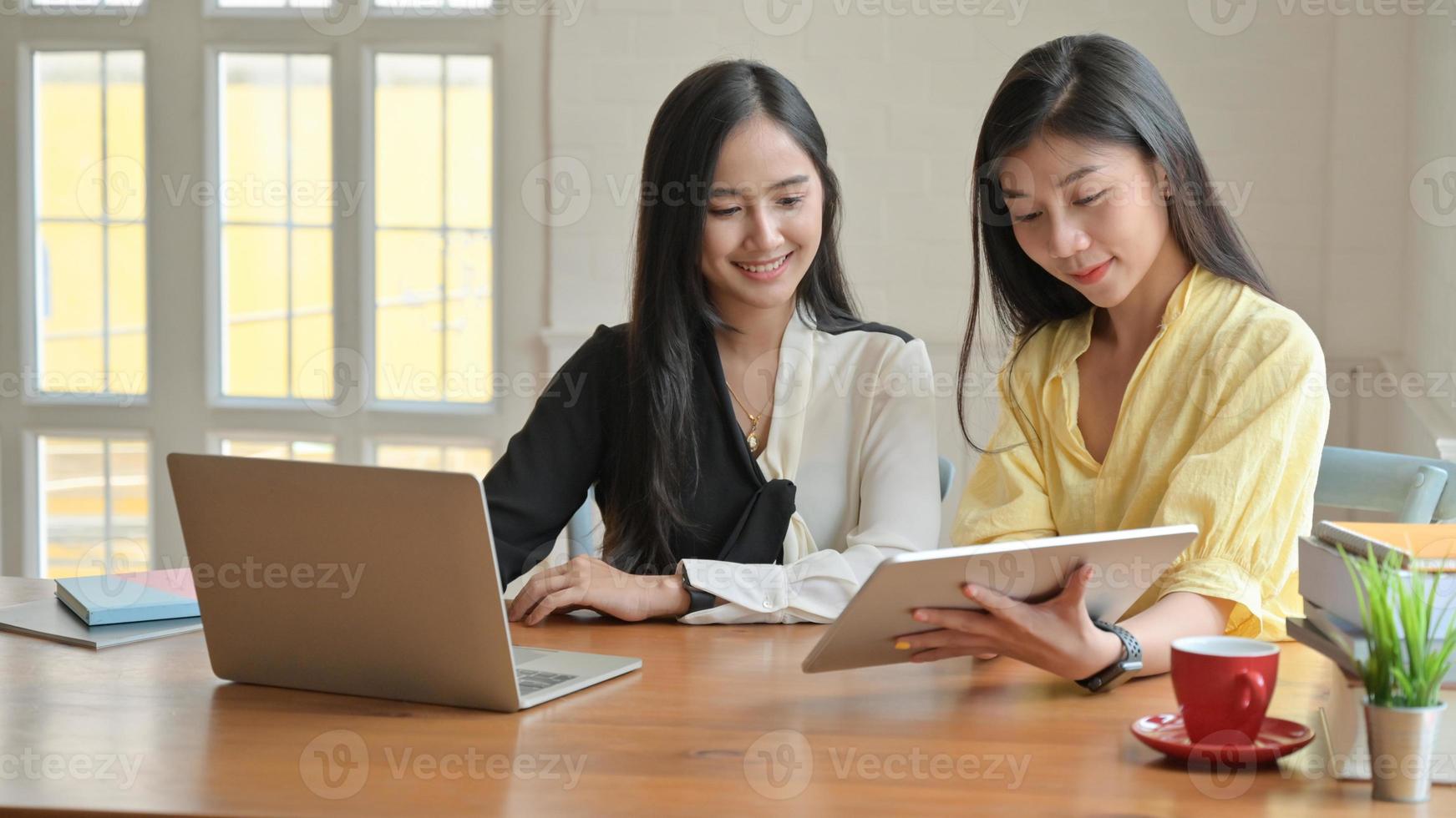 dos mujeres asiáticas con laptop y tableta trabajando en casa. para prevenir la propagación del coronavirus. foto