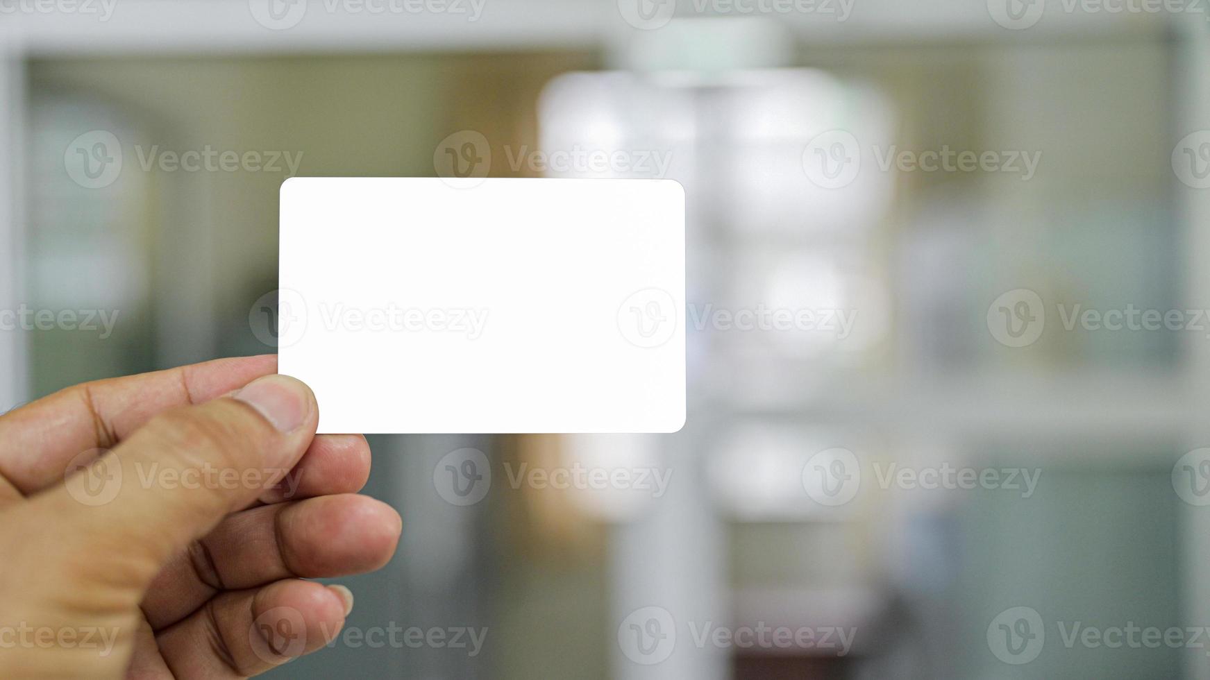 Close - up shot of Hand showing business card. photo