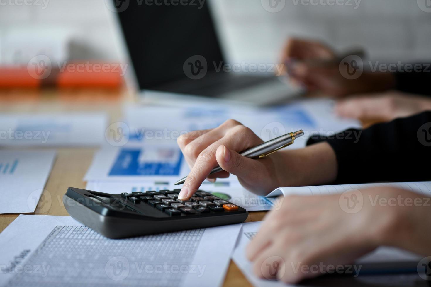 Business girl working with calculator on the desk in office. photo