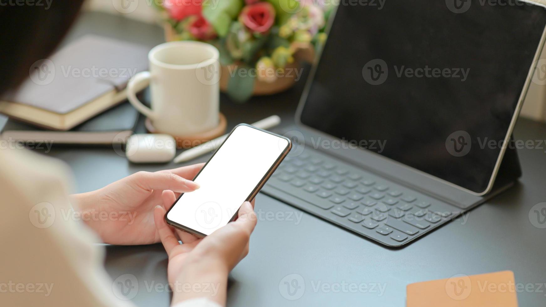 Businesswoman searching for important information with a smartphone for her new project. photo