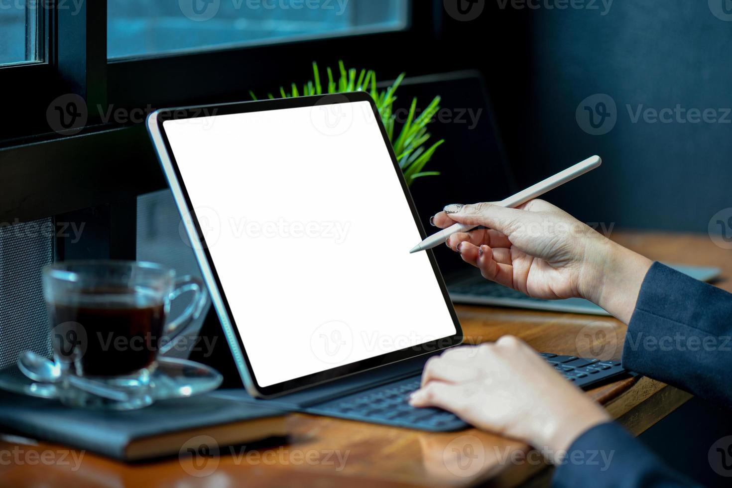 Businesswoman working on blank screen modern tablet in office. photo