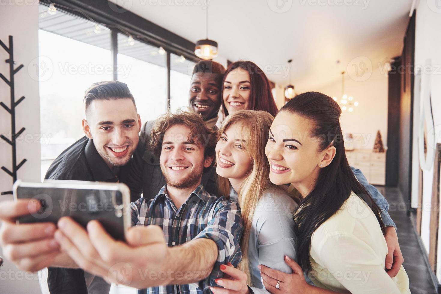 Group portrait of Cheerful old friends communicate with each other, friend posing on cafe, Urban style people having fun, Concepts about youth togetherness lifestyle. Wifi connected photo