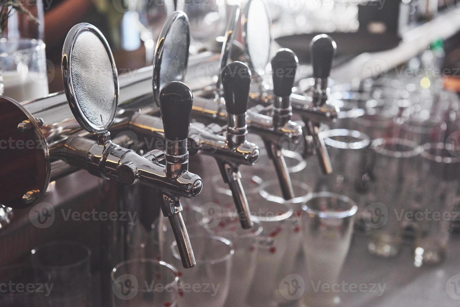ready to pint of beer on a bar in a traditional style wooden pub photo