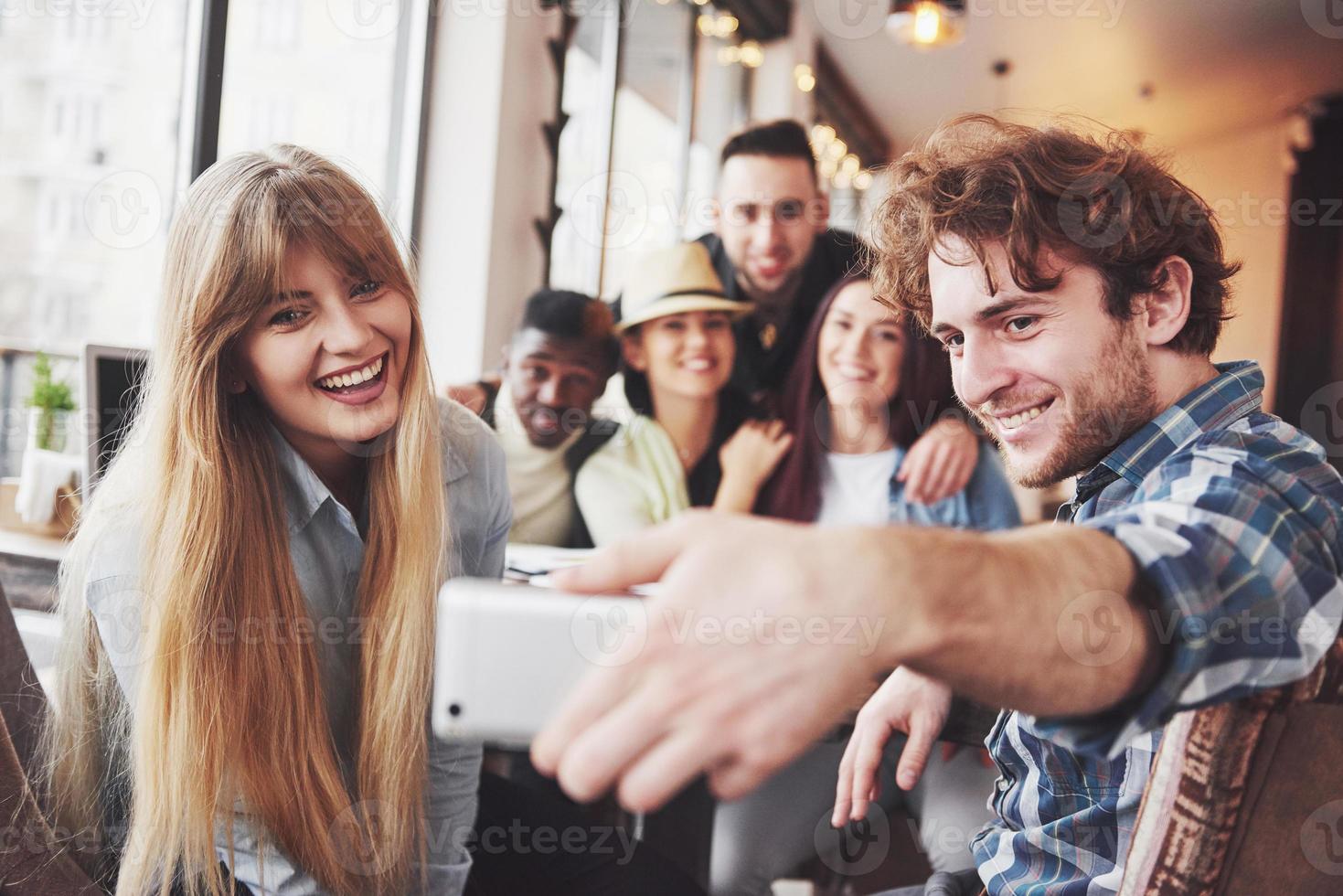 Group portrait of Cheerful old friends communicate with each other, friend posing on cafe, Urban style people having fun, Concepts about youth togetherness lifestyle. Wifi connected photo