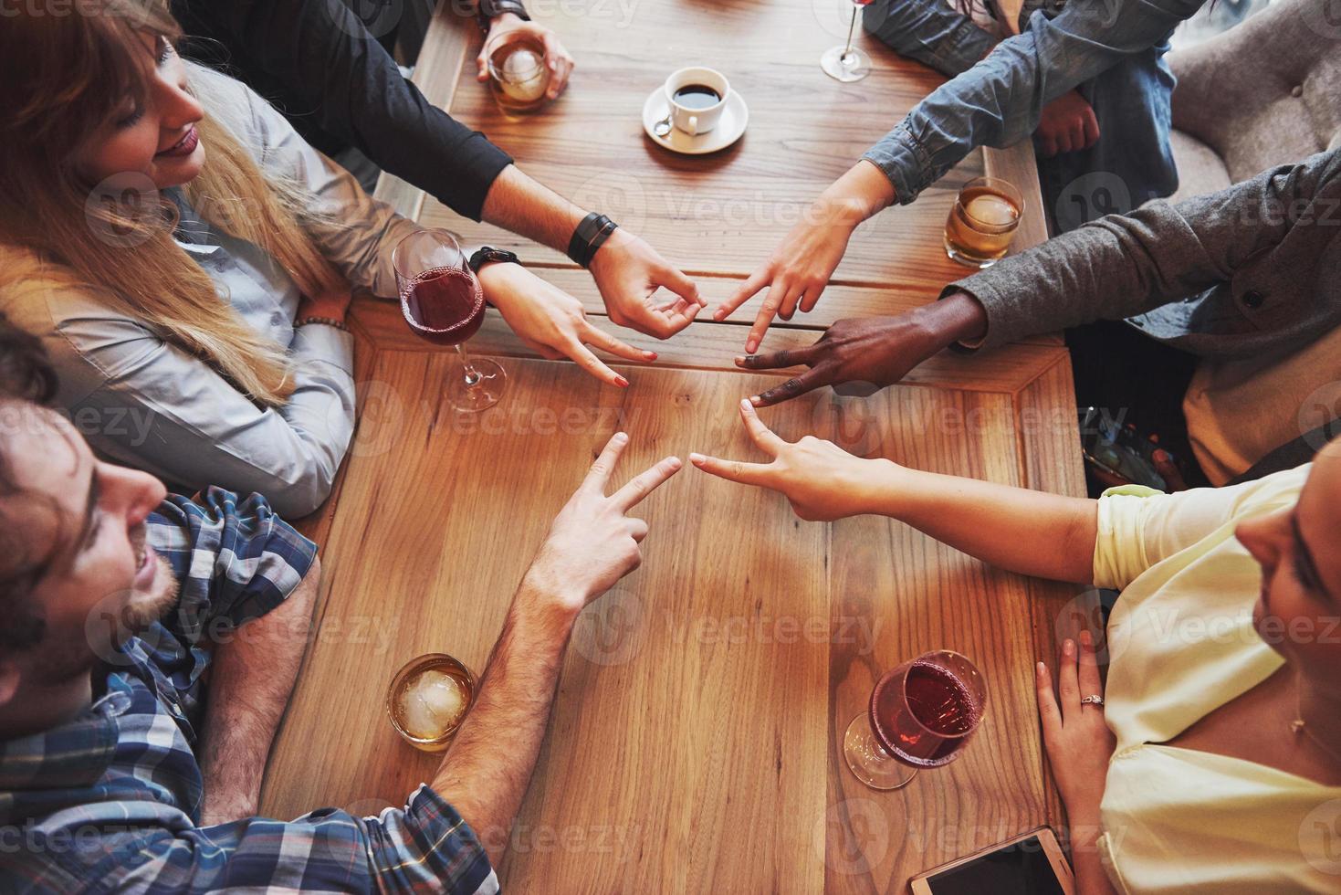 Close up top view of young people putting their hands together. Friends Doing a Star Shape with fingers showing unity and teamwork photo