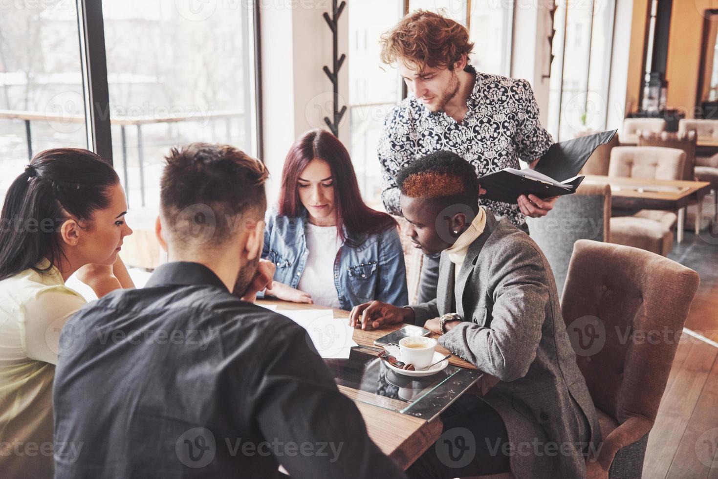 grupo de empresarios vestidos casualmente discutiendo ideas. profesionales creativos se reunieron para discutir los temas importantes del nuevo proyecto de inicio exitoso. concepto de lluvia de ideas de trabajo en equipo foto