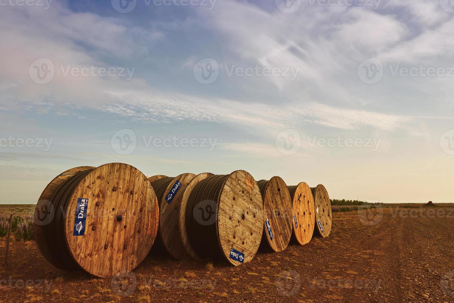 Large rolls of black cables on blue sky background photo