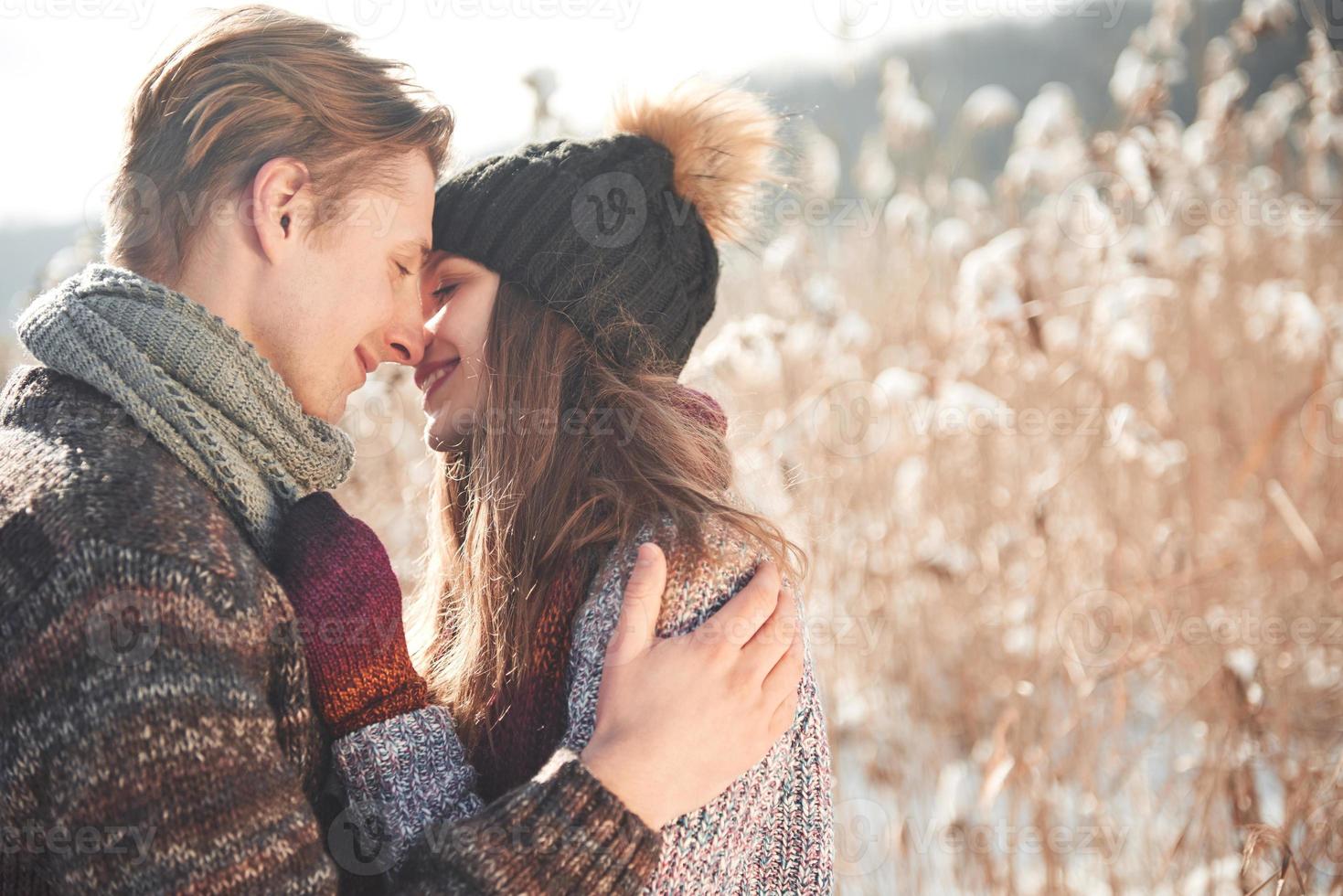 Happy couple playful together during winter holidays vacation outside in snow park photo