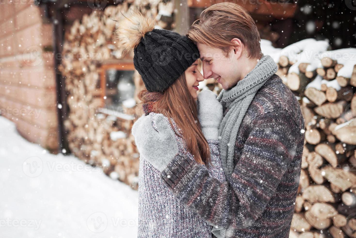 christmas happy couple in love embrace in snowy winter cold forest, copy space, new year party celebration, holiday and vacation, travel, love and relations photo