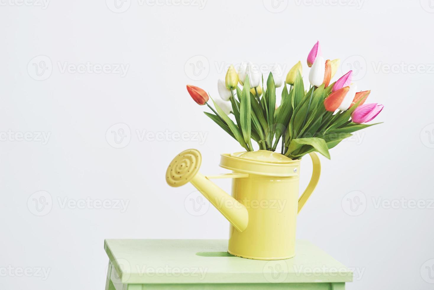 yellow funnel with small colored flowers tulps. Beutiful spring flowers photo