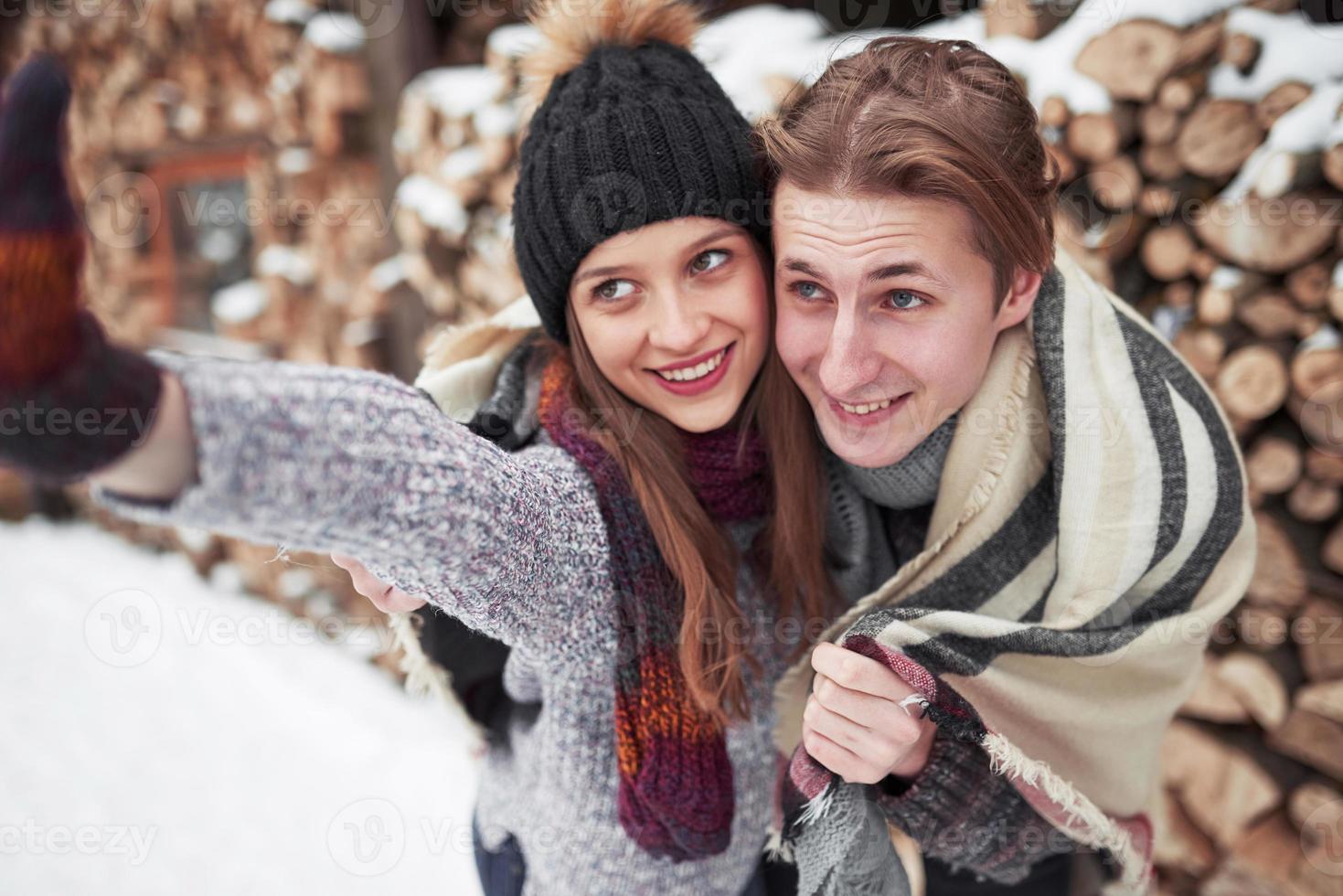 people, season, love and leisure concept - happy couple having fun over winter background photo