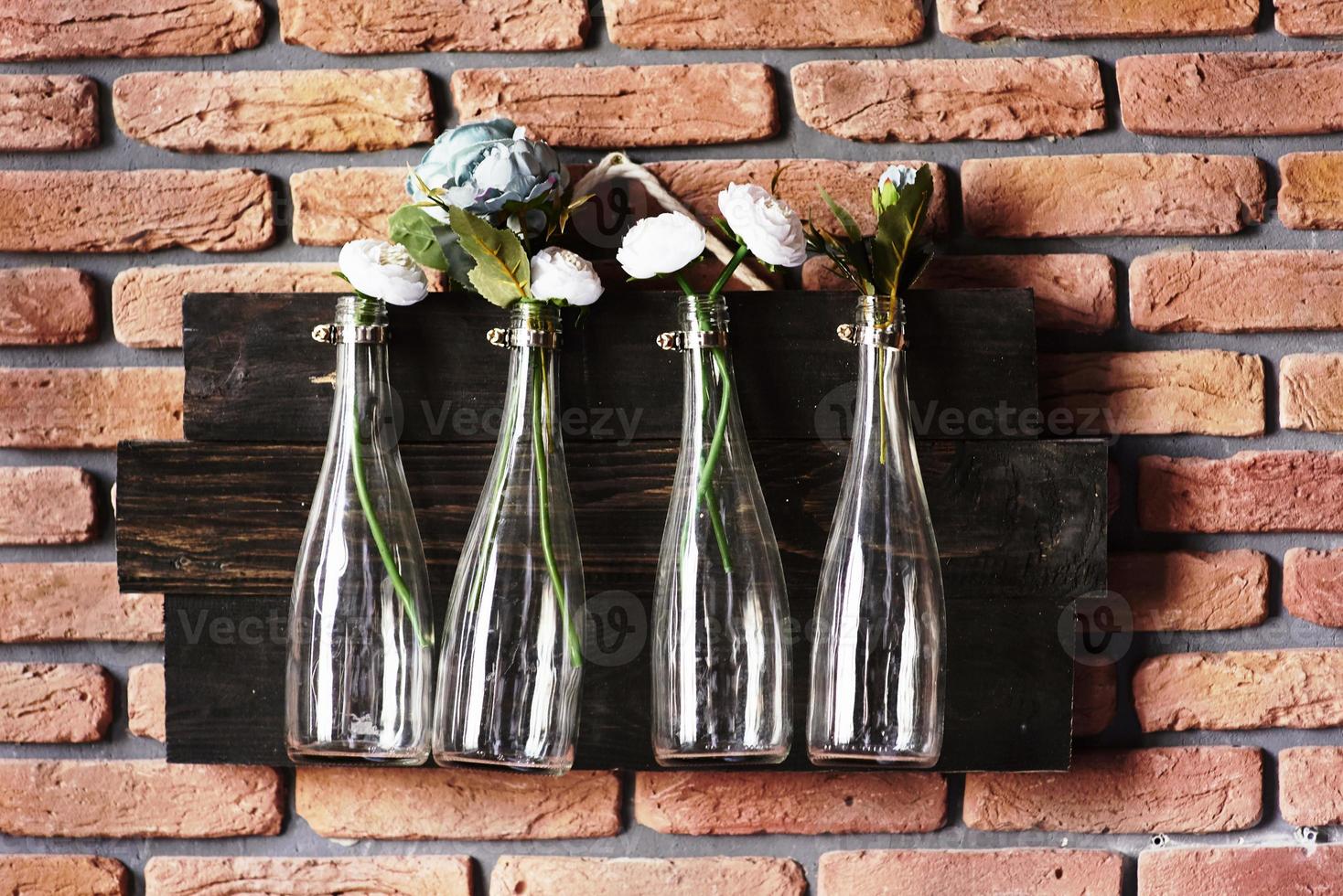 Interior decoration with bottles on brick wall with flowers. Great for wedding photo