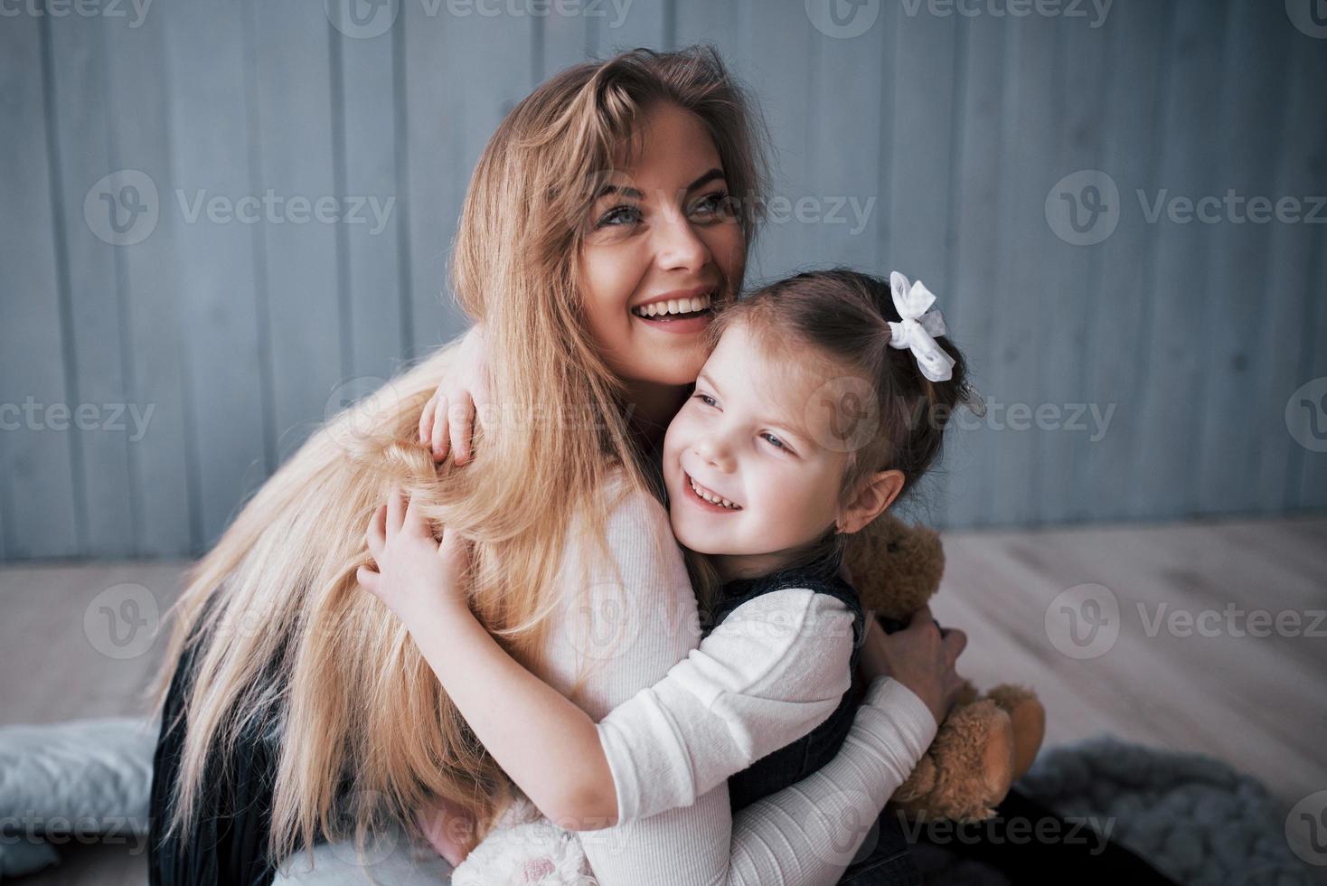 Happy loving family. Mother and her daughter child girl playing and hugging photo