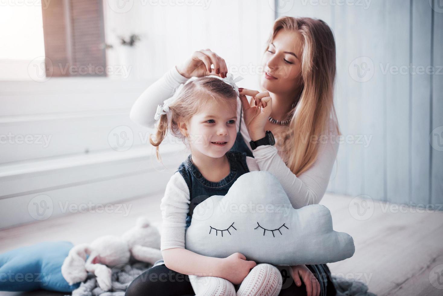 Happy loving family. Mother and her daughter child girl playing and hugging photo