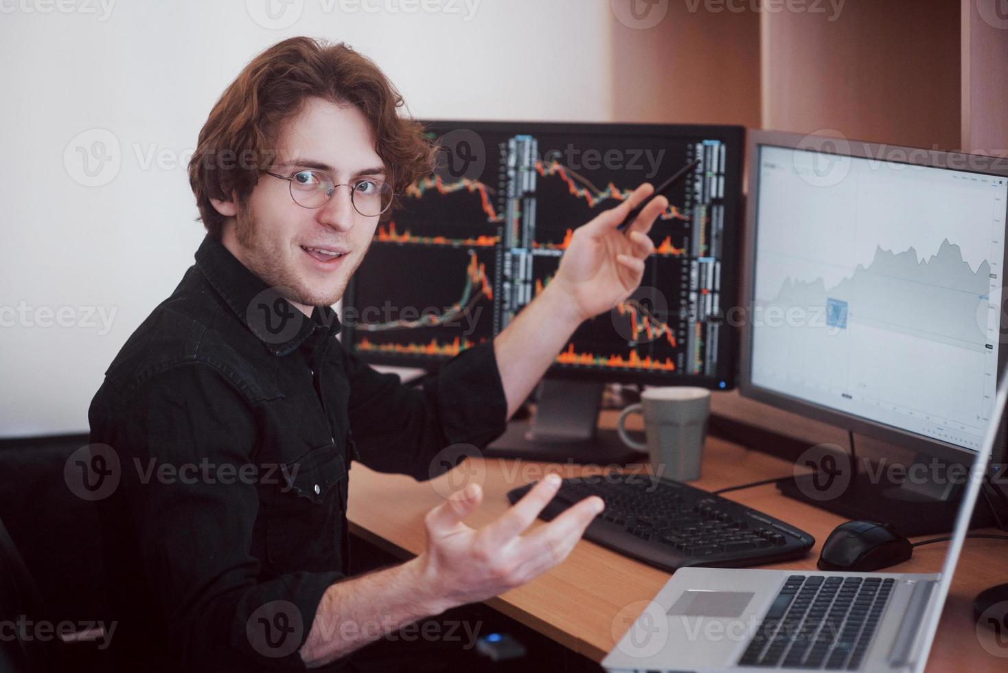 Businessmen trading stocks online. Stock broker looking at graphs, indexes and numbers on multiple computer screens. Business success concept photo