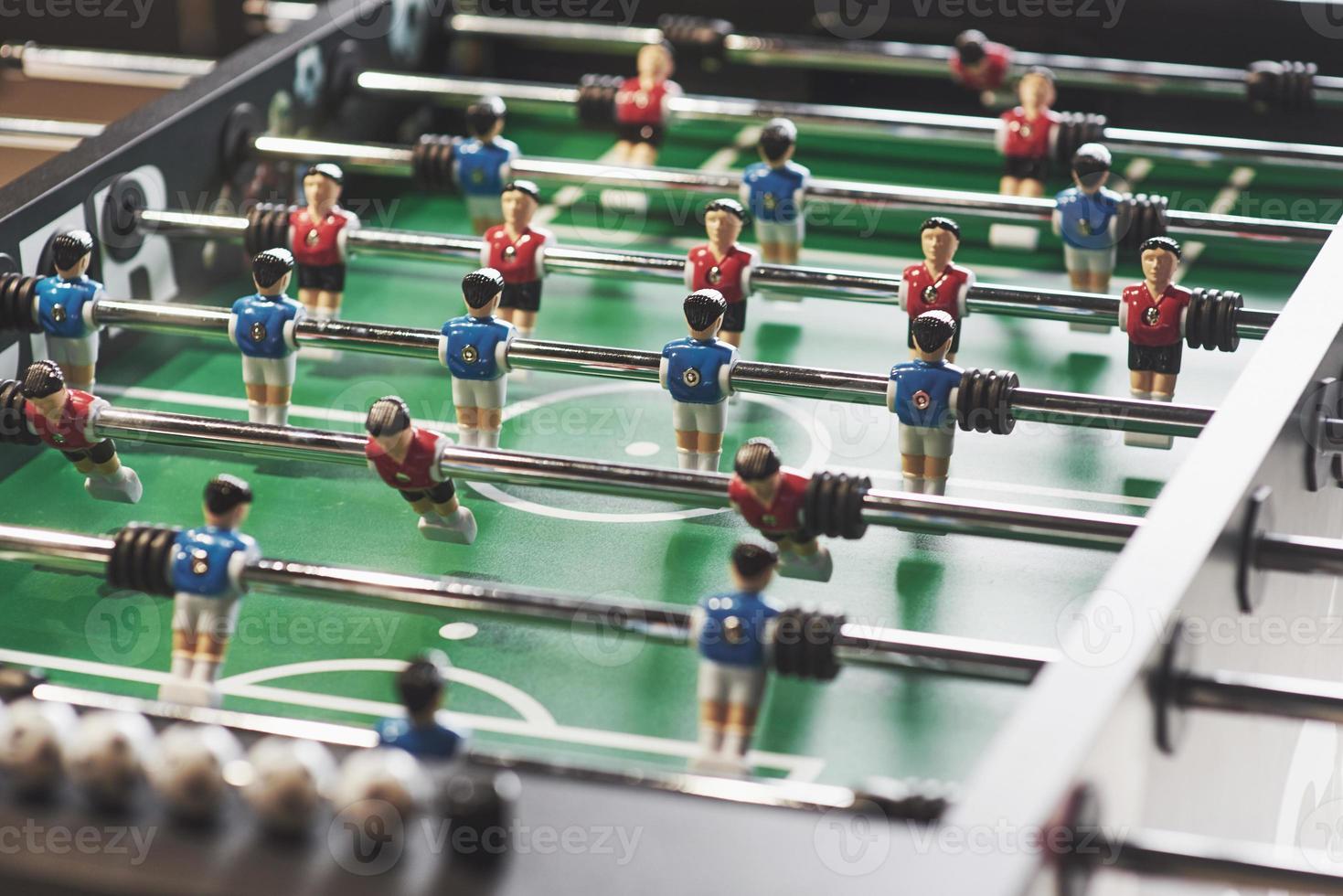 Table football in the entertainment center. Close-up image of plastic players in a football game photo