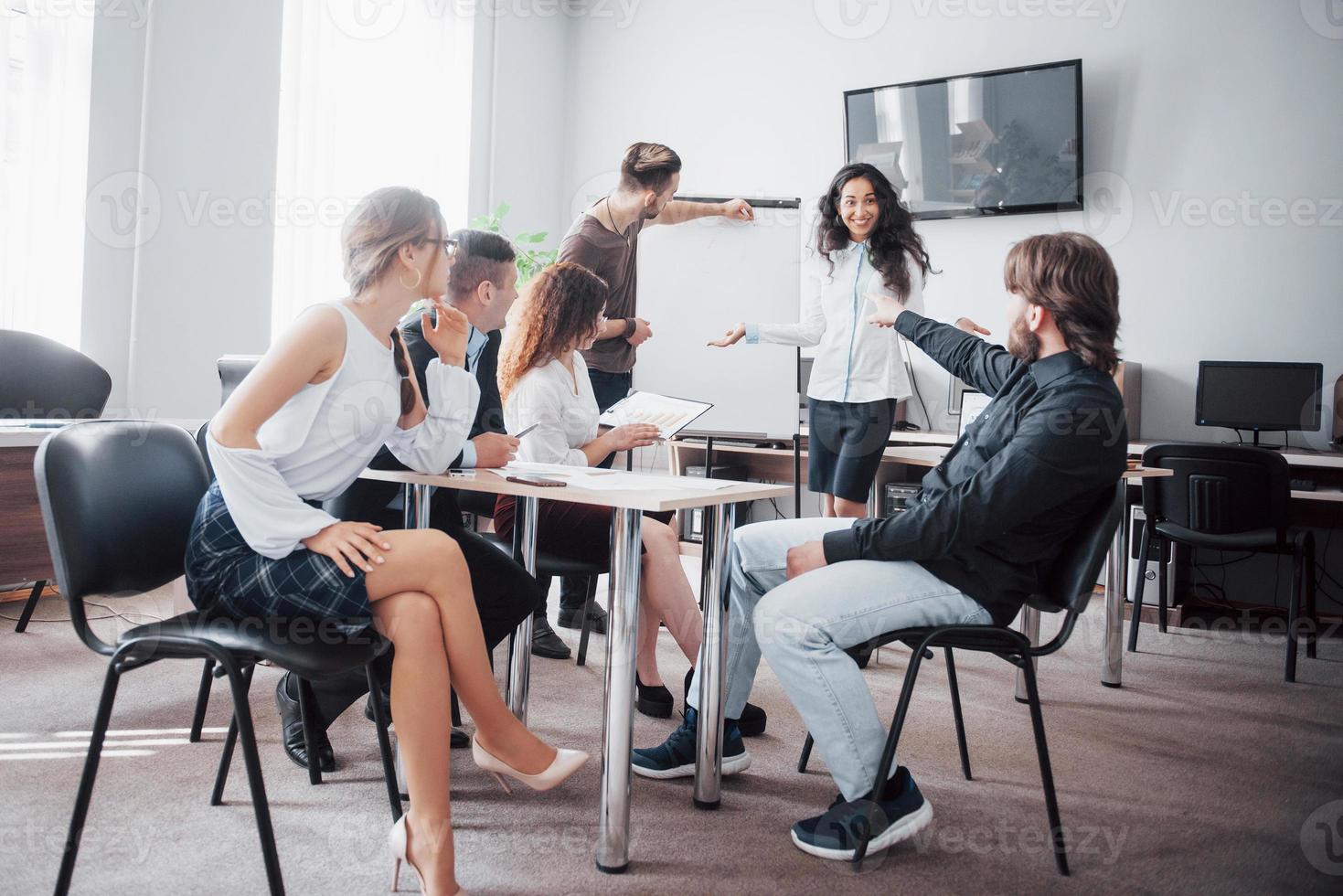 Successful business people are talking and smiling during in office. photo