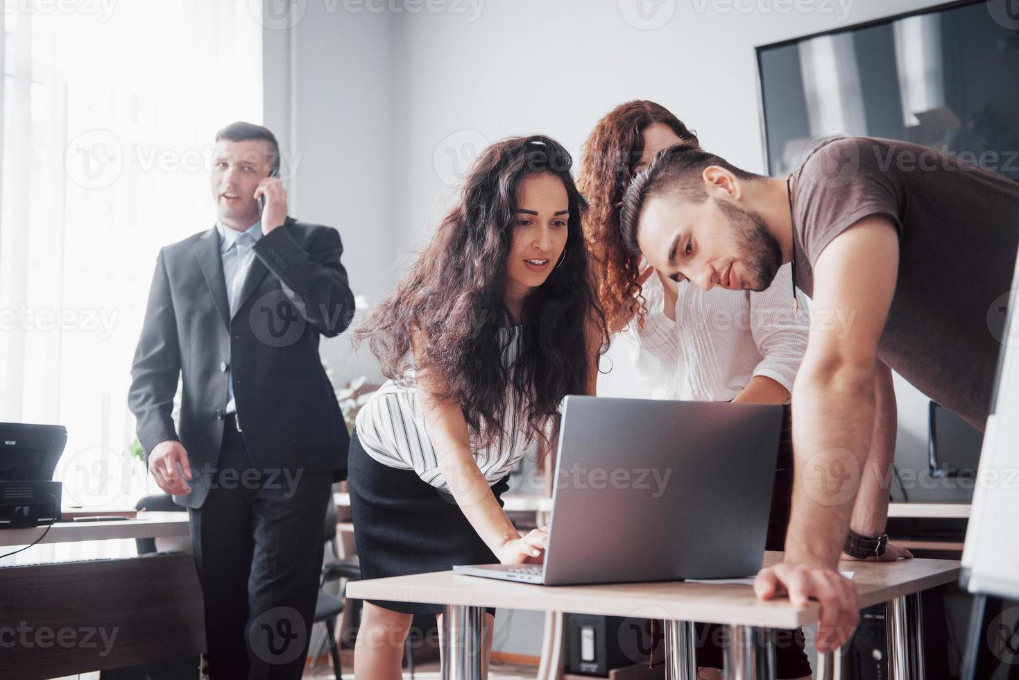 Colleagues communicate with work questions in modern office space. photo