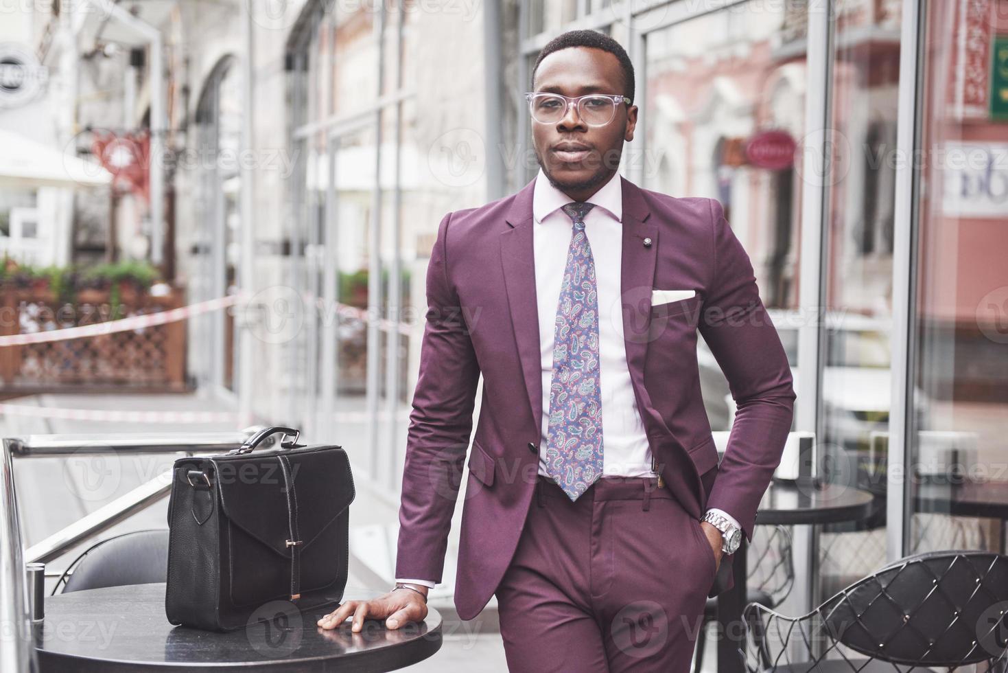 Young businessman with a briefcase near a beautiful office. Business meeting photo