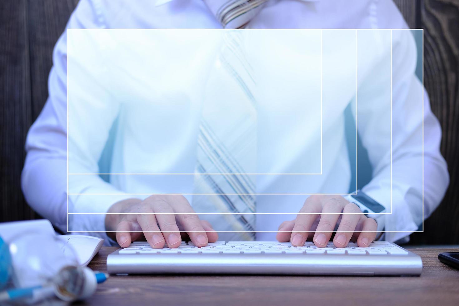 Businessman working on computer in office, typing keyboard photo