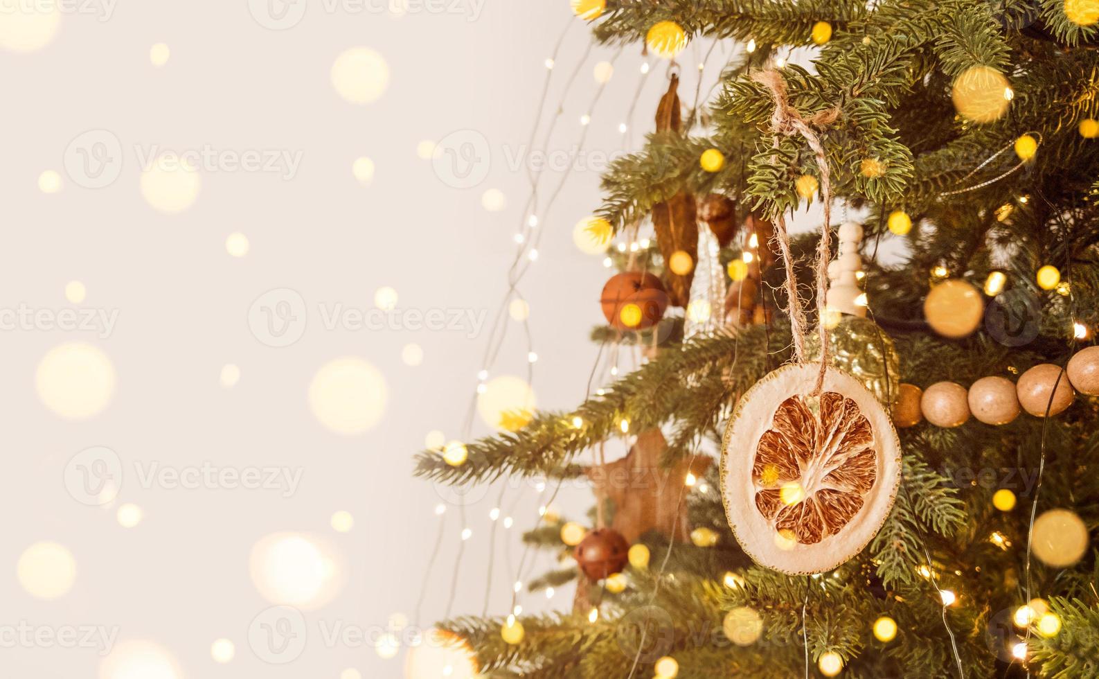 Christmas tree decorated in scandinavian style, rustic ornament and defocused lights. Stock photo with copy space