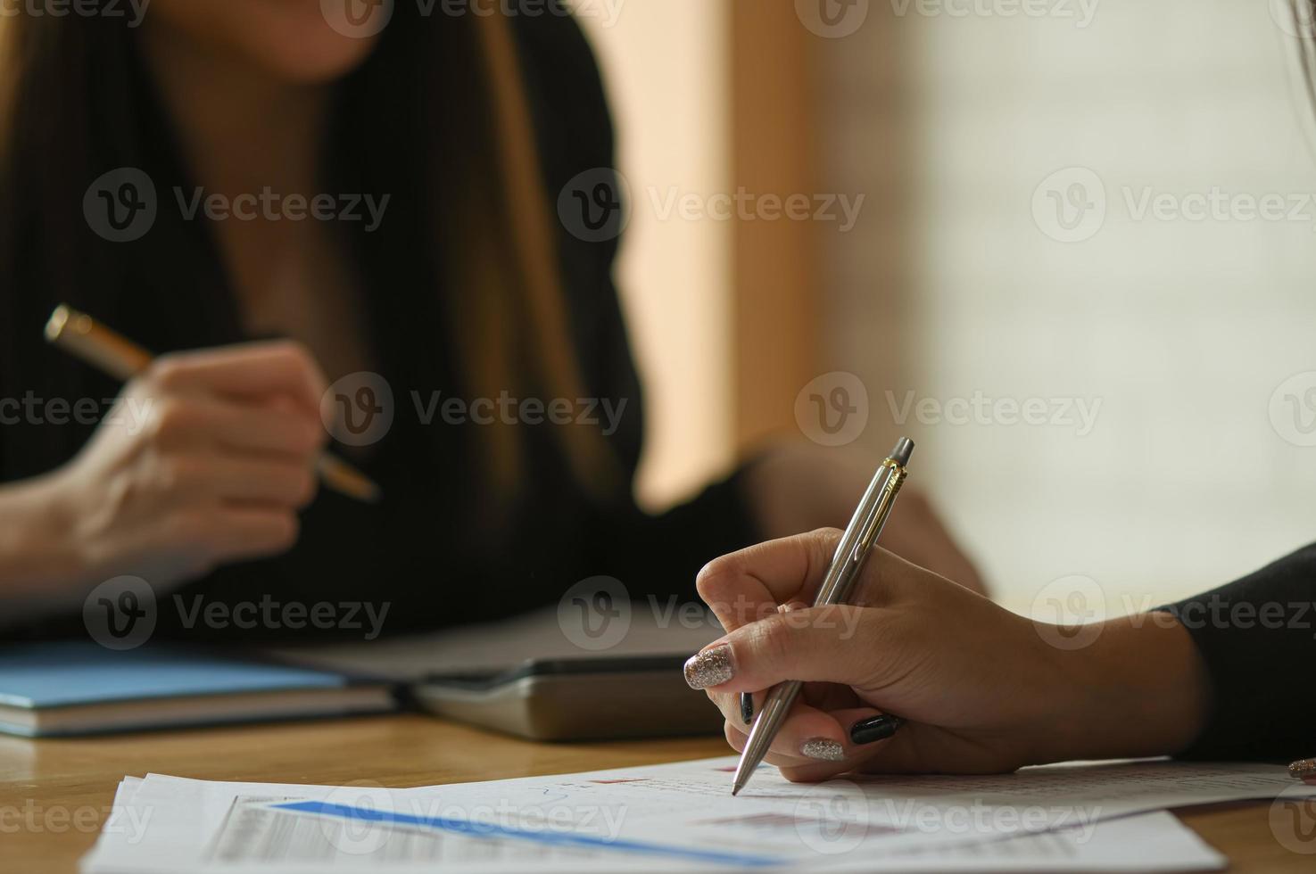 El equipo contable femenino está analizando los datos para resumir el presupuesto. foto