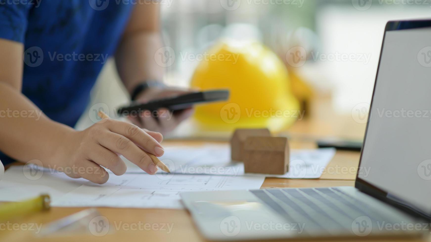 Designer is calculating and editing the house plan to present the client. photo