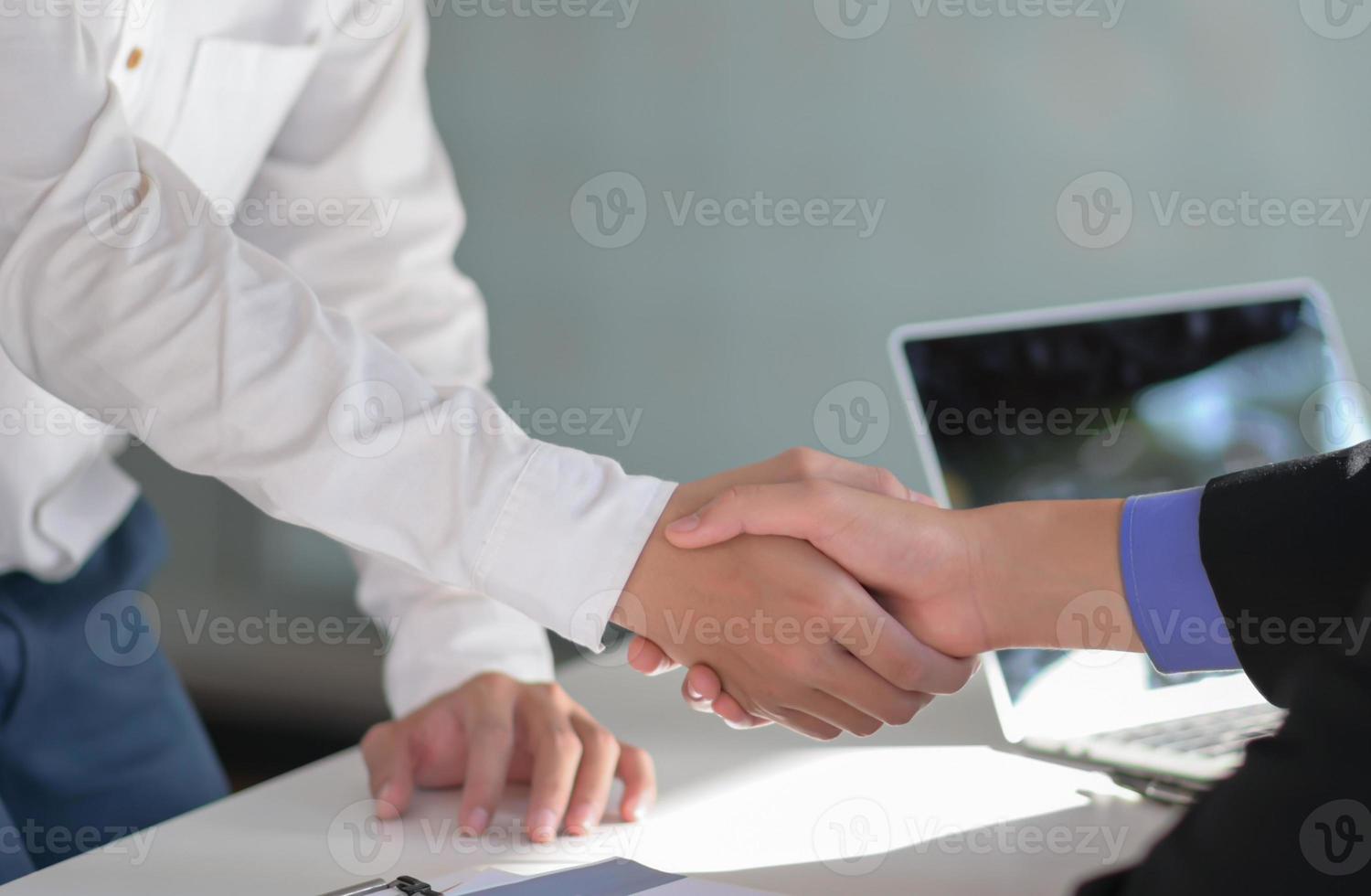 Cropped shot of Handshake to congratulate the joint project. photo