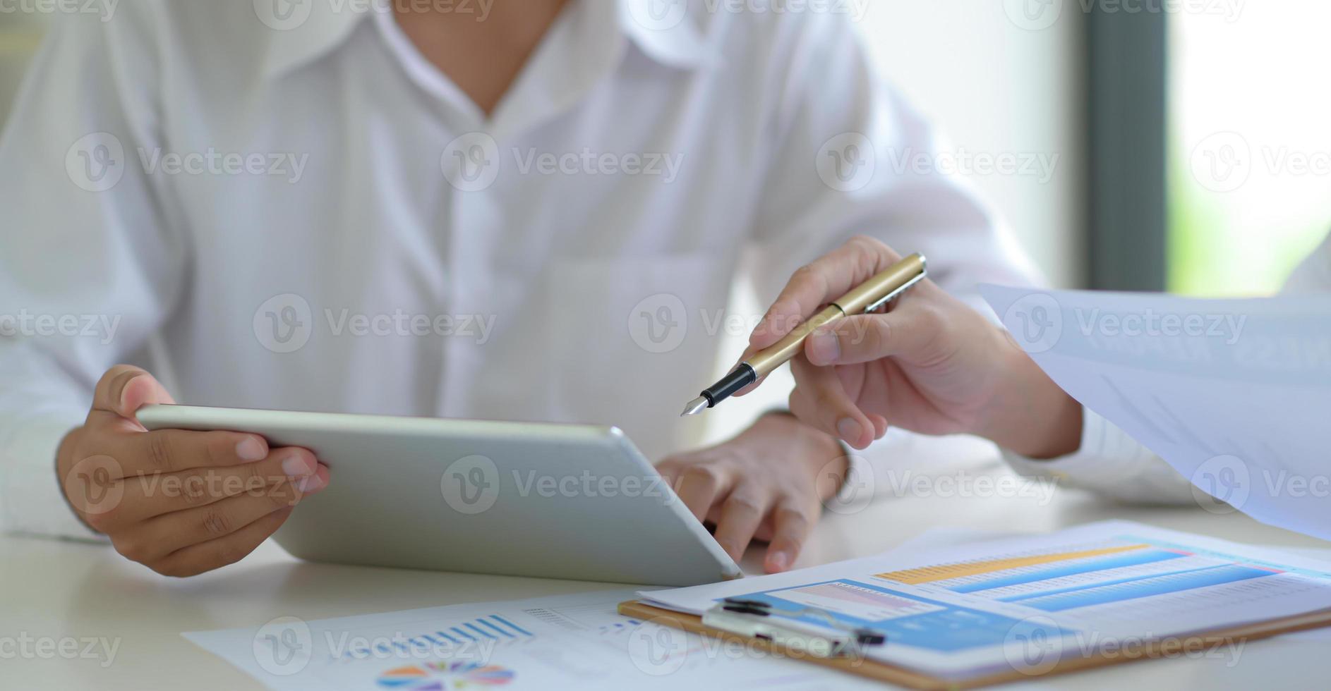 Stock market experts use tablet to follow the news to assess the volatile stock market situation. photo